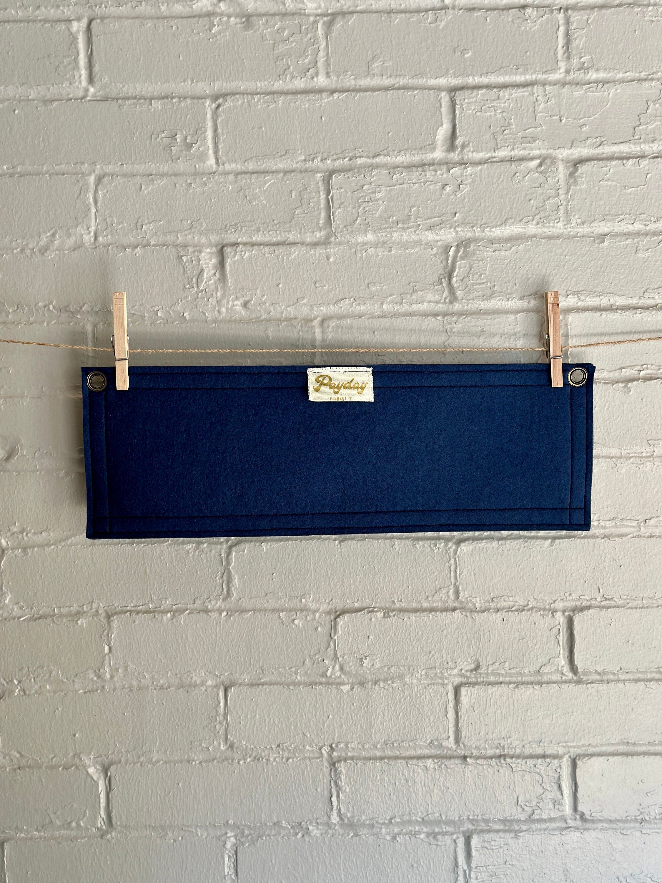 Back of a navy felt banner with navy trim and bright white lettering which reads "every second counts"