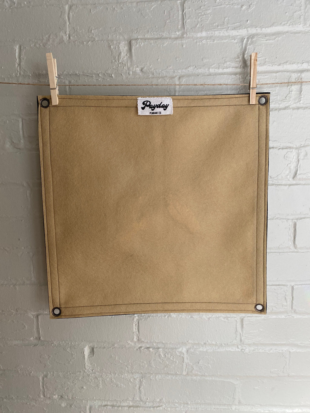 Backside view of a light brown felt banner with black trim, and album art from band Godspeed You! Black Emperor