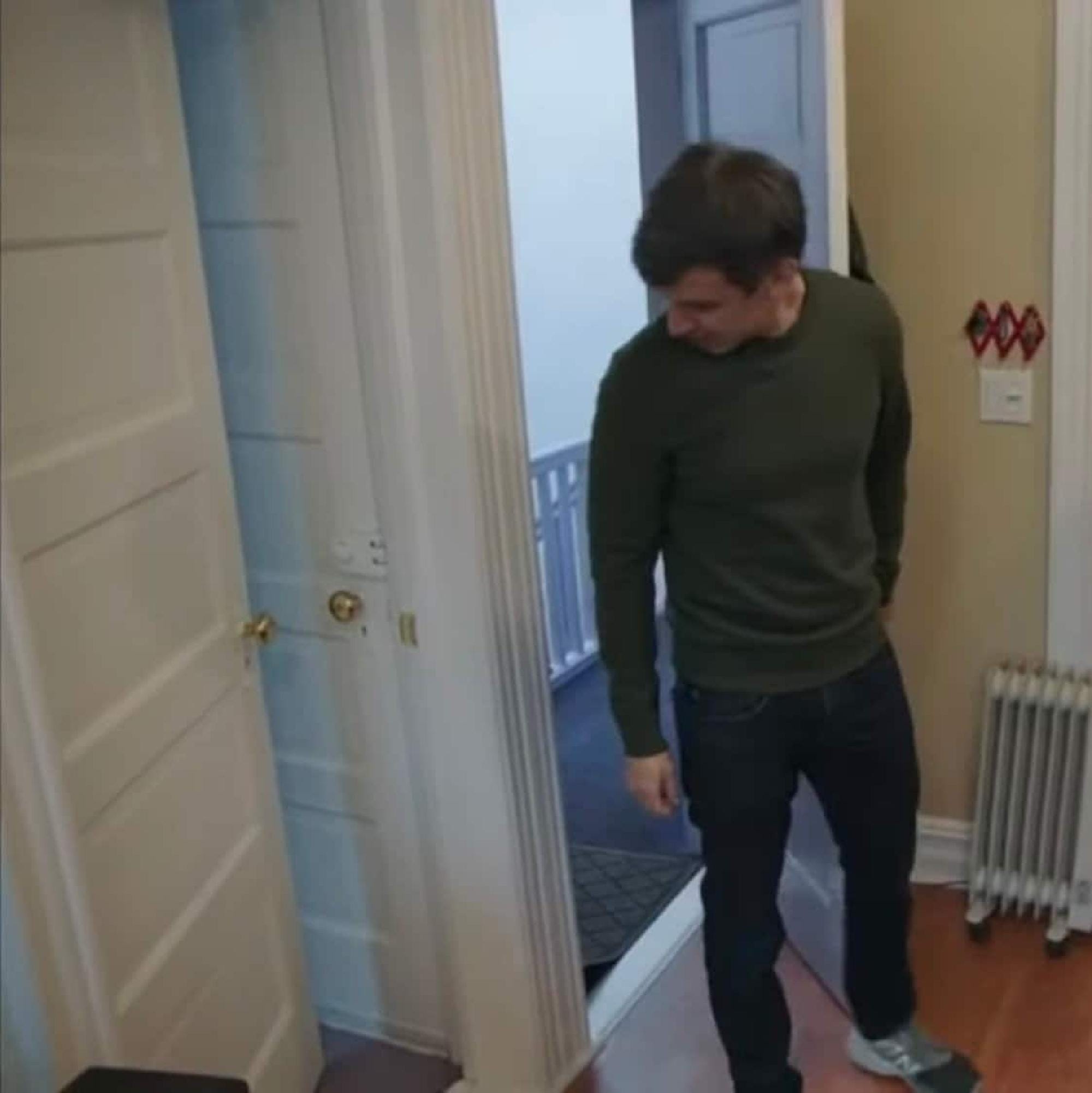 A still frame from Nathan Fielder's "The Rehearsal" where he stares at an area of an apartment with multiple doors