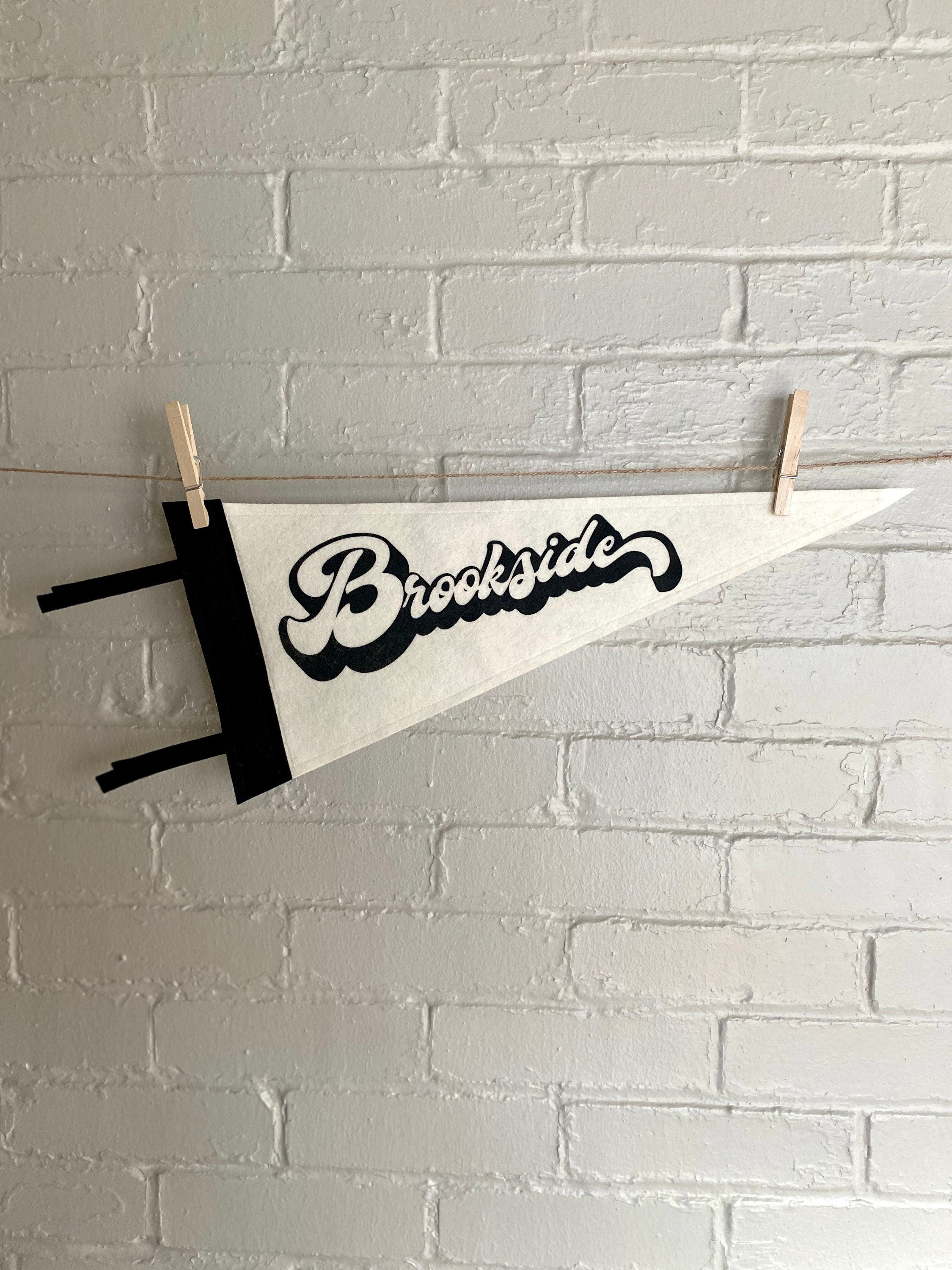 A black and white pennant and "Brookside" printed on