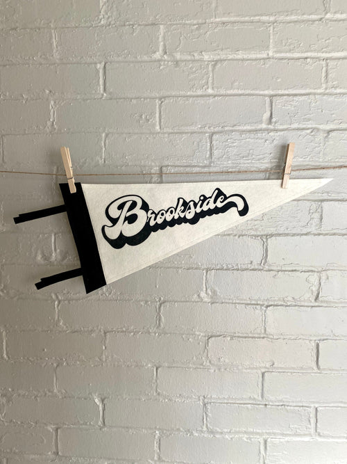 A black and white pennant and "Brookside" printed on