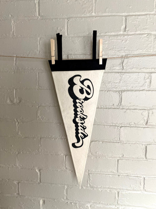 A black and white pennant and "Brookside" printed on