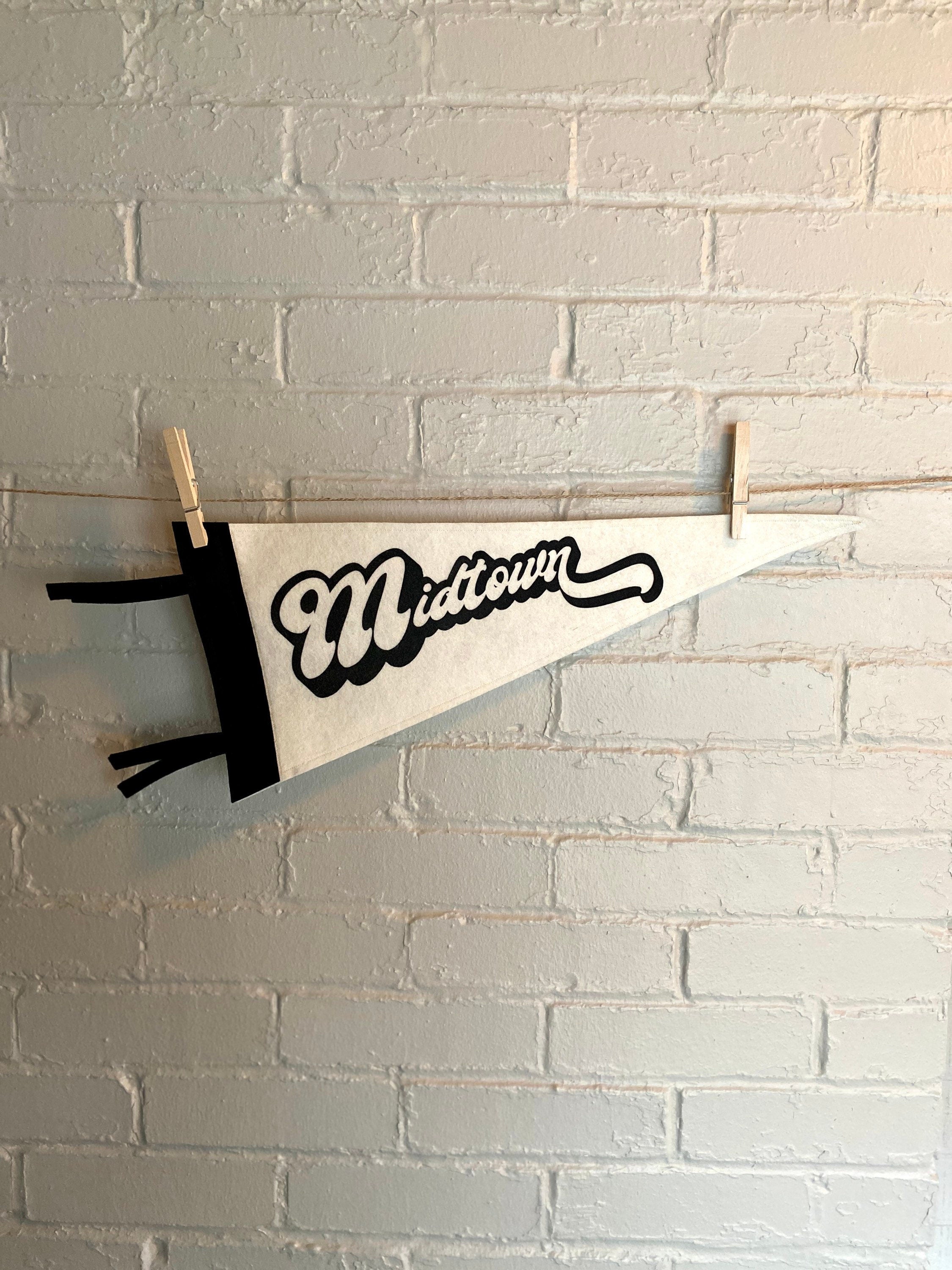 A black and white pennant that reads "Midtown" with the pennant horizontal
